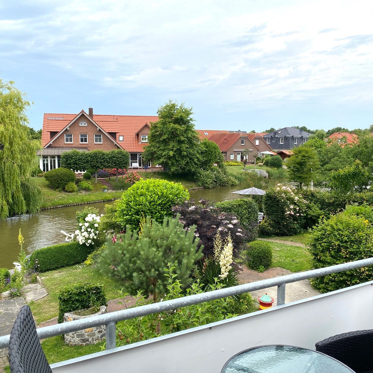 Fewo SCHÖNE AUSSICHT: Blick vom Balkon auf den Wasserlauf des Sieltiefs und den Gemeinschaftsgarten